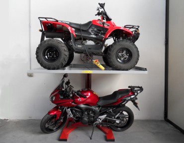 Quadbike lifted and motorbike parked